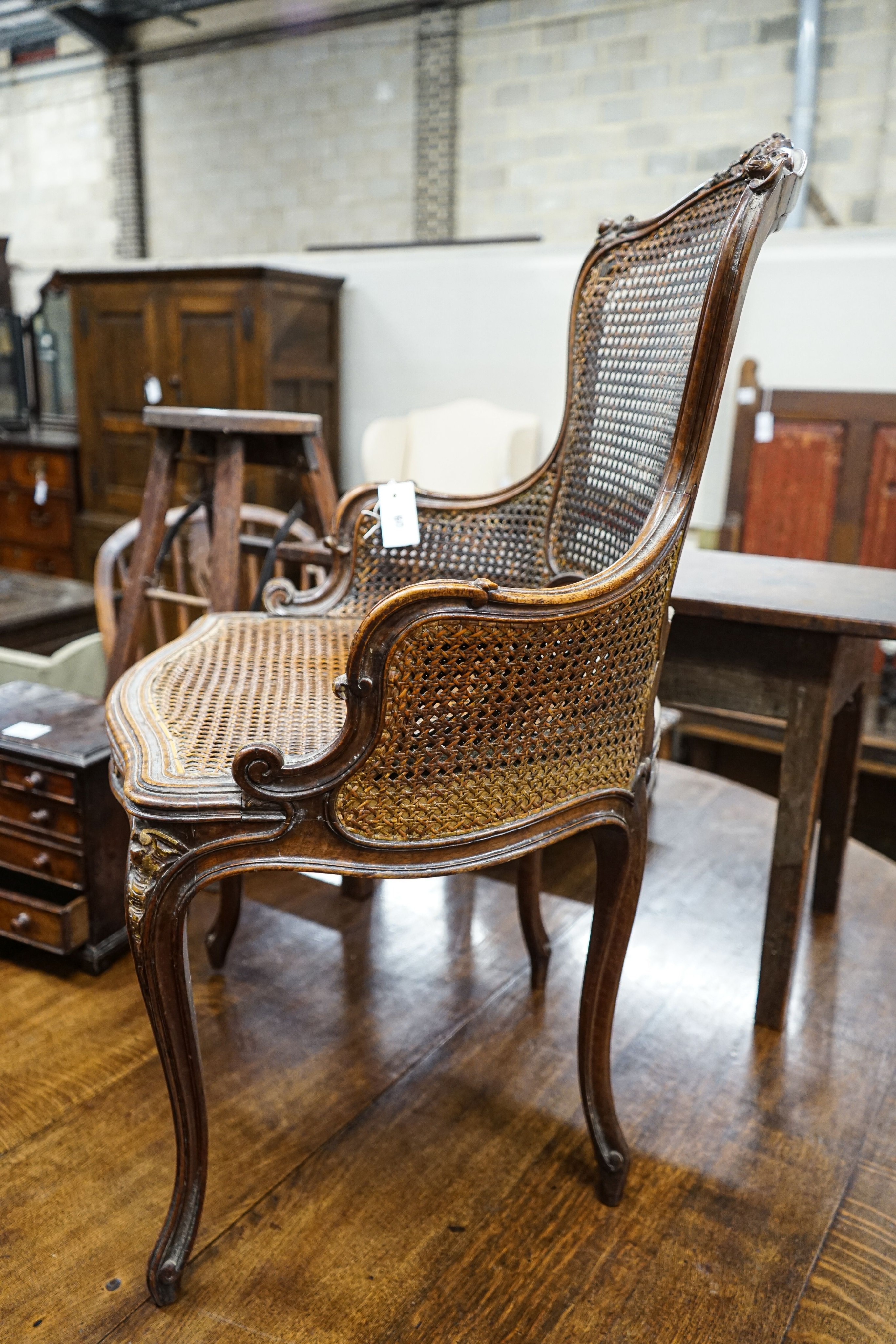 A 19th century French carved and caned walnut salon chair, width 52cm, depth 46cm, height 87cm